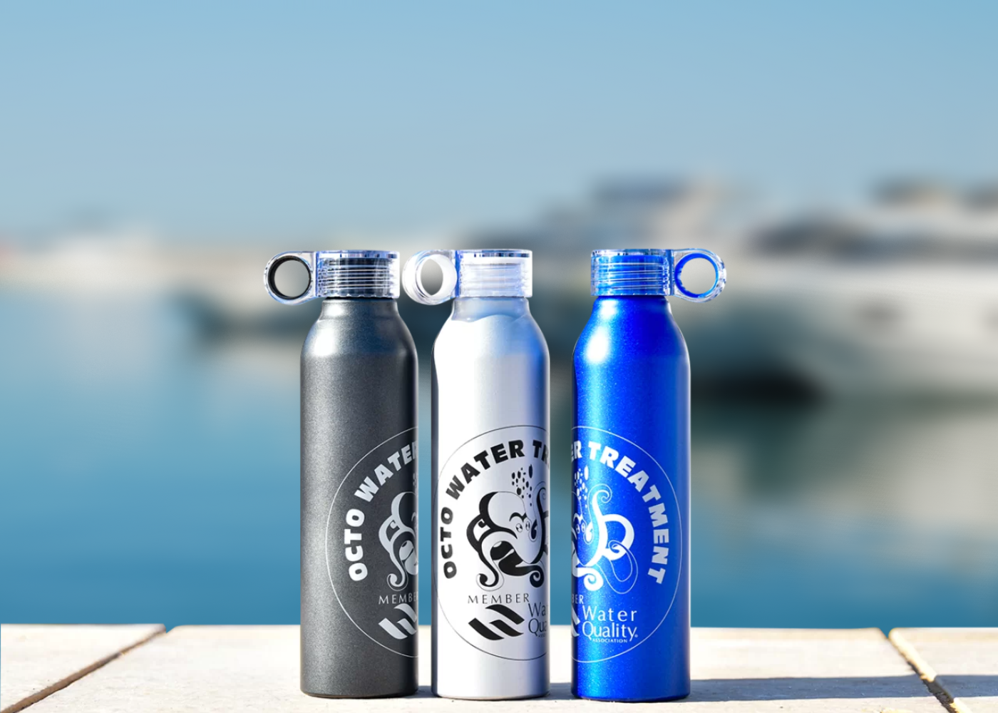 Octo Marine Brand Bottles On Dockside In Front Of Marina